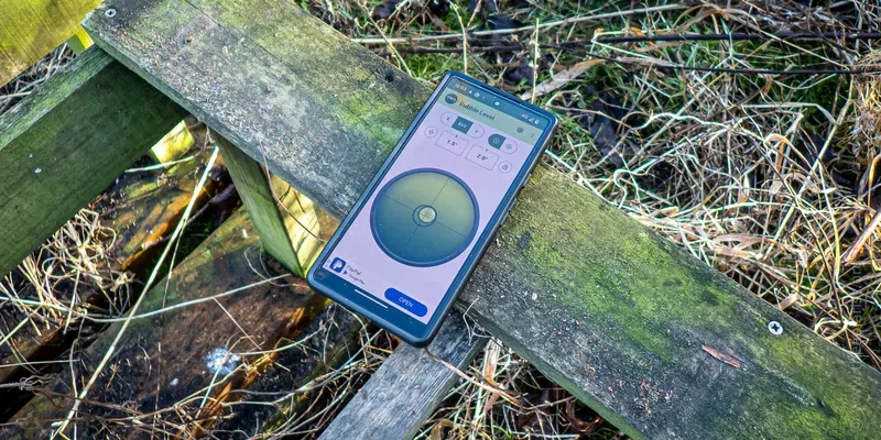 Wooden beehive stand with a mobile phone spirit level